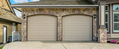 Home with stone exterior and brown garage doors