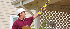 Contractor inspecting outside of house